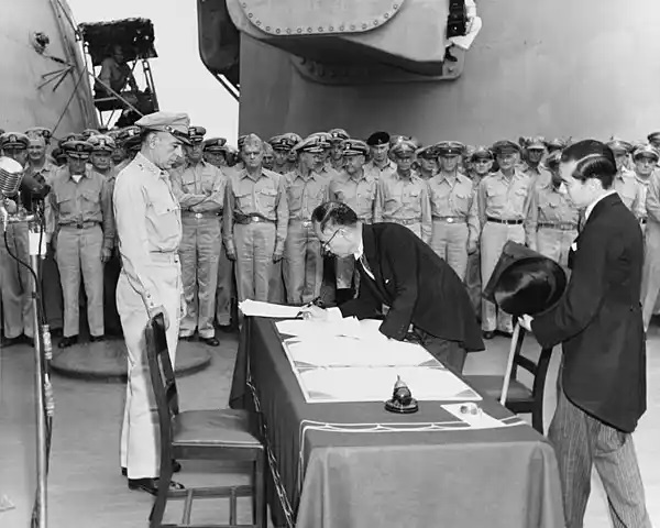 Japanese Foreign Minister Mamoru Shigemitsu signs the Instrument of Surrender on behalf of the Japanese Government, on board USS Missouri (BB-63), 2 September 1945.